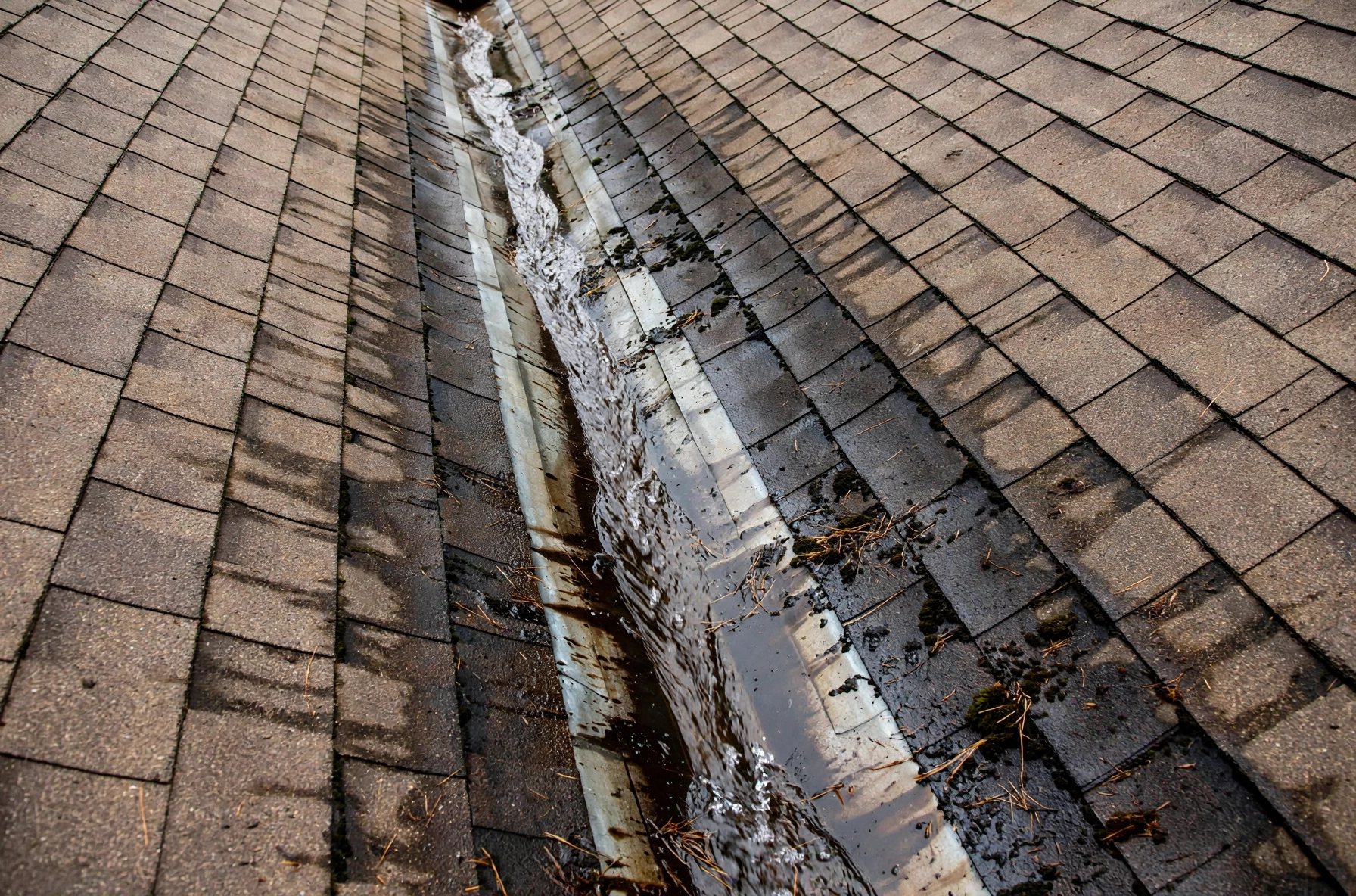 Close-up of a roof valley on an Owasso home where flashing failure causes leaks